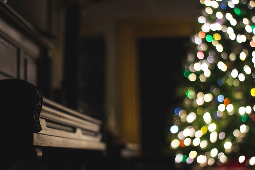 Piano with Christmas tree backdrop